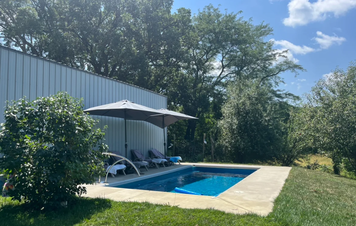 Fiberglass pool with surrounding patio in a country backyard, photographed by homeowner Vicky